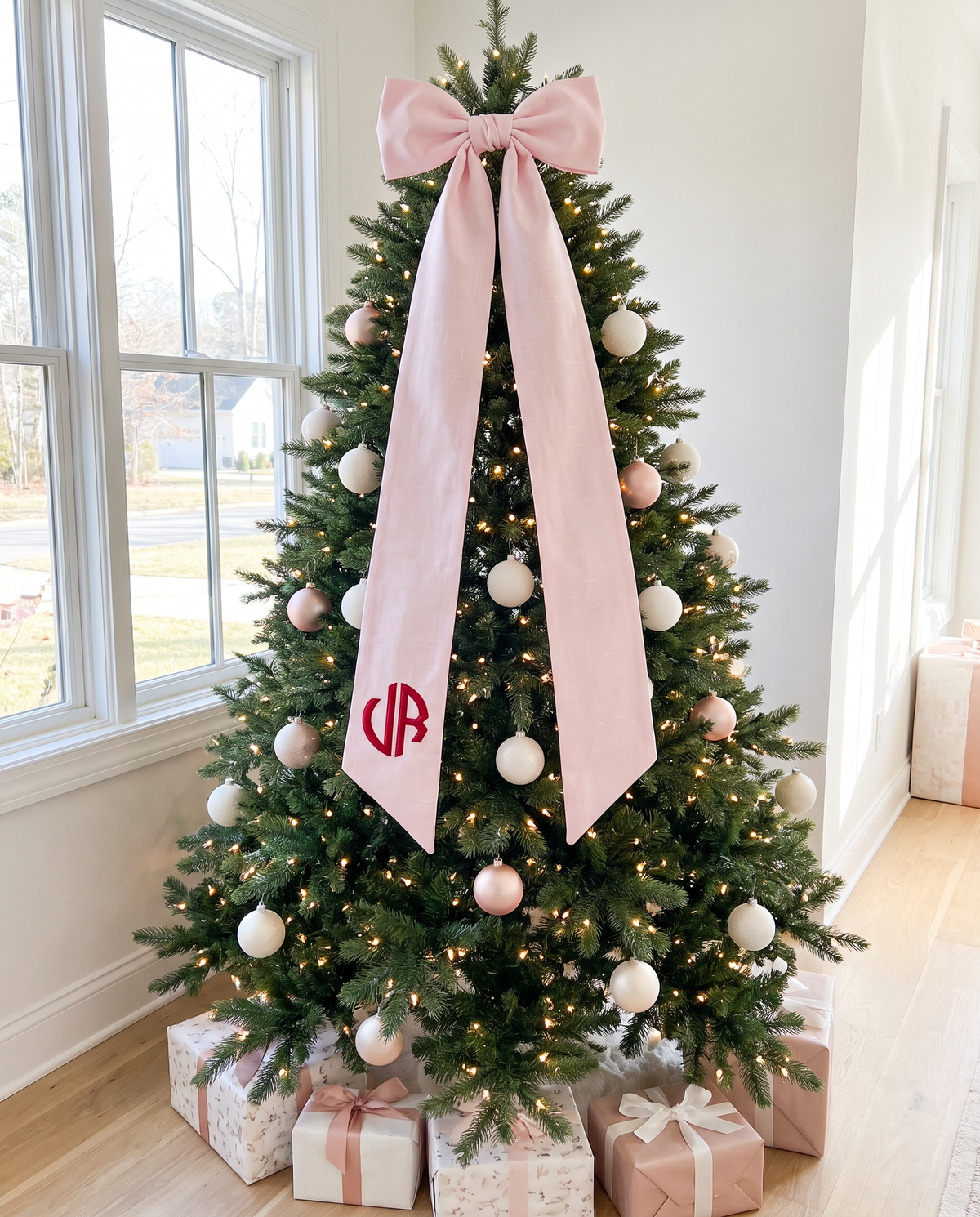 Light pink bow sash used as a Christmas tree accent with pink and white ornaments