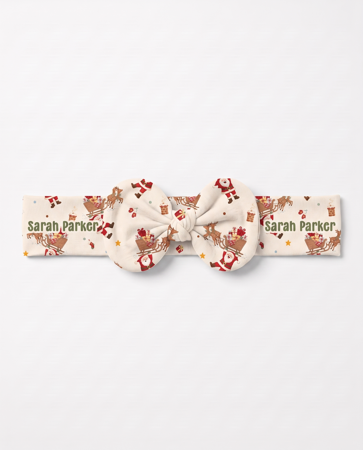 Personalized Santa's Joyride bow headband with the baby's name, on white