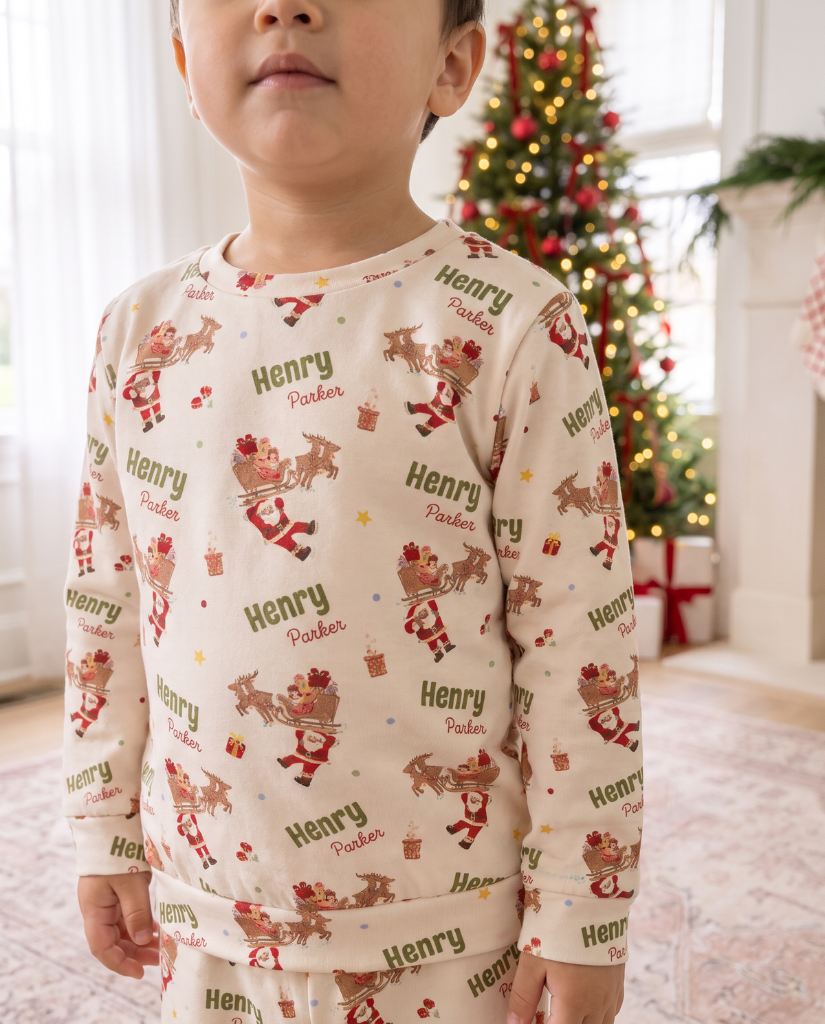 Close view of the kids Santa's Joyride pajama top personalized with the name Henry