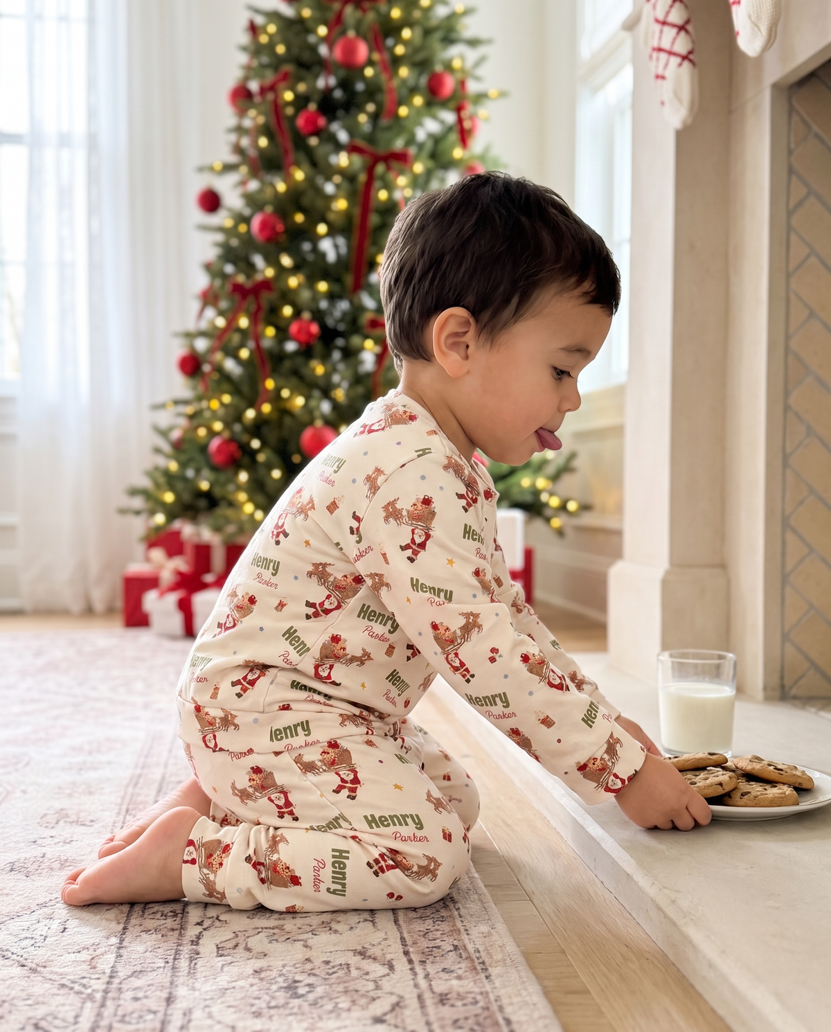 Little boy in Santa's Joyride pajamas leaving cookies and milk for Santa