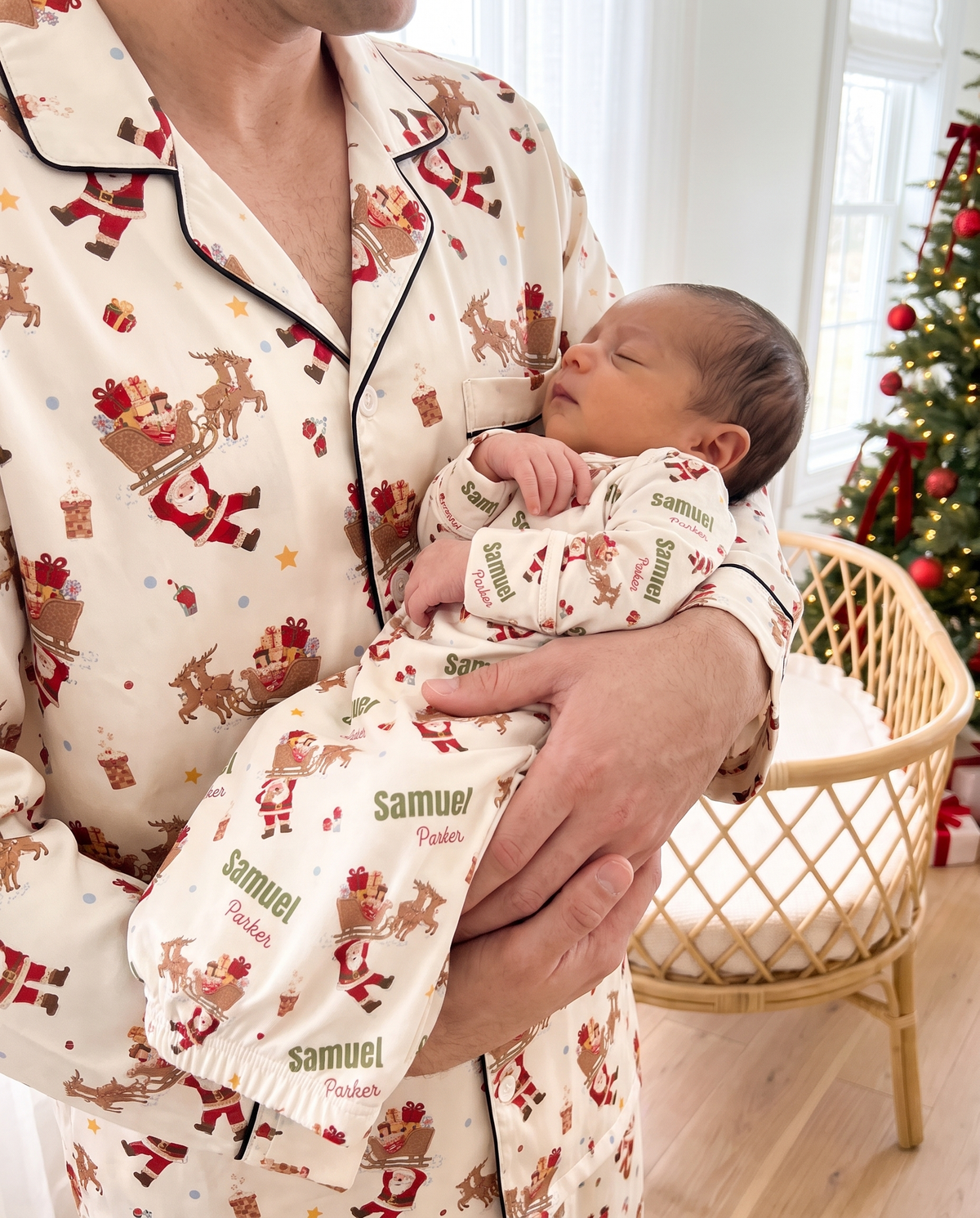 Parent in matching pajamas cradling a newborn in the personalized Santa's Joyride sleep gown