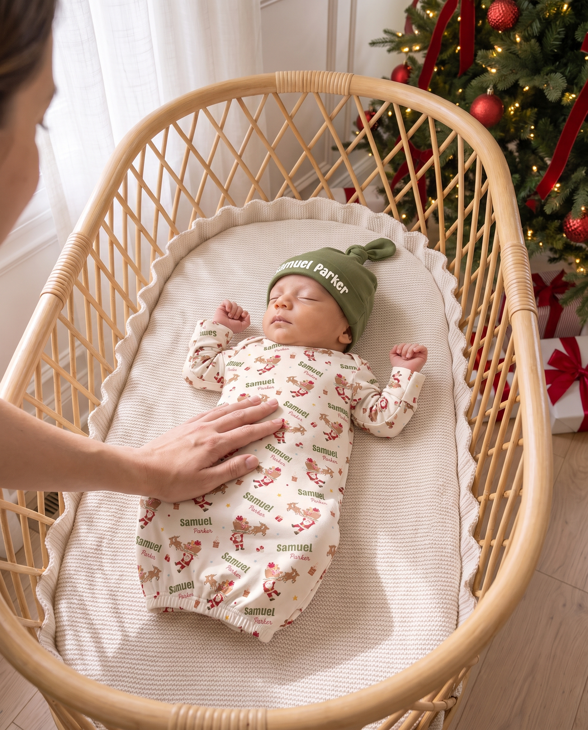 Parent tucking in a newborn in the Santa's Joyride sleep gown and knotted hat
