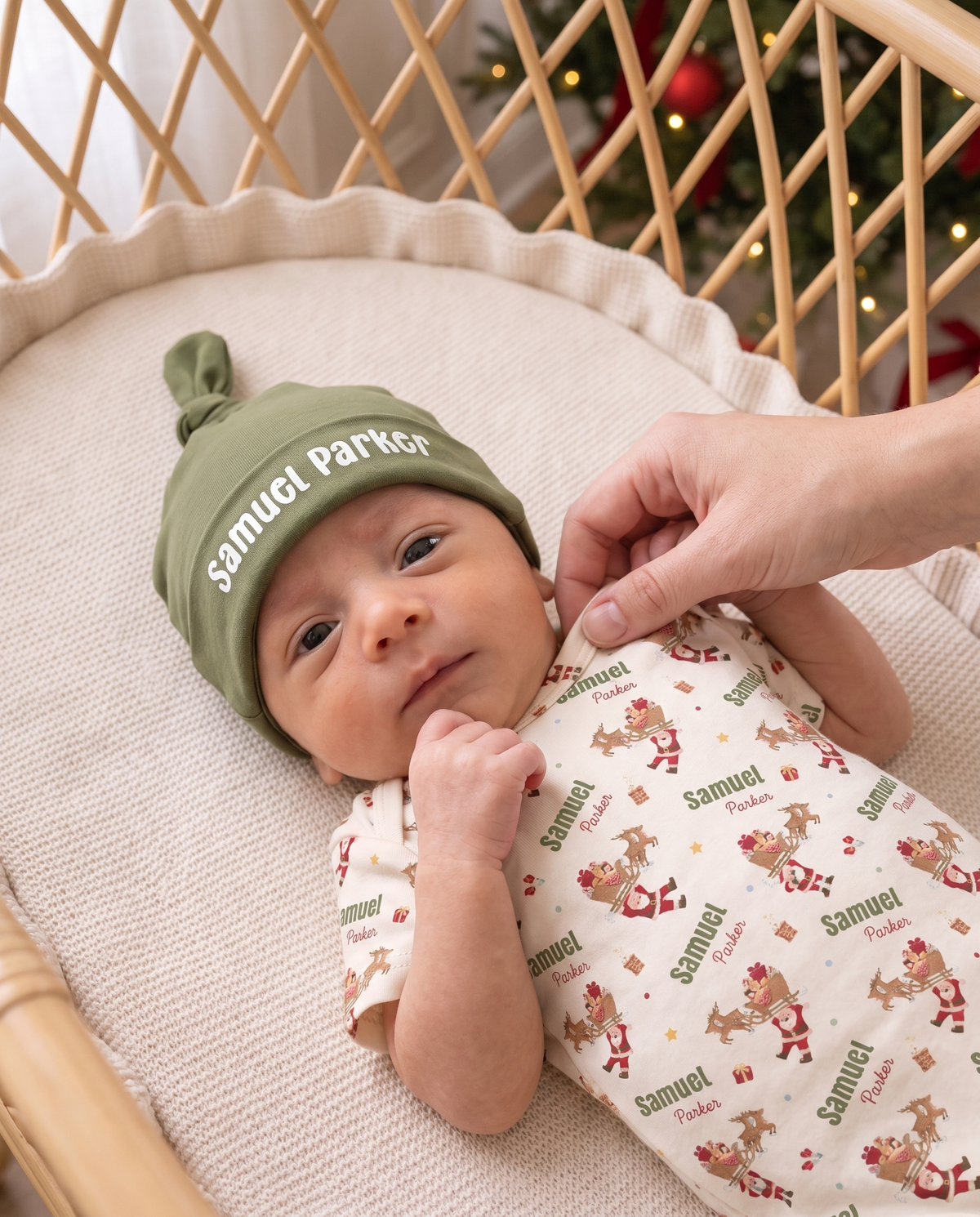 Close view of baby in the Santa's Joyride bodysuit and personalized olive knotted hat