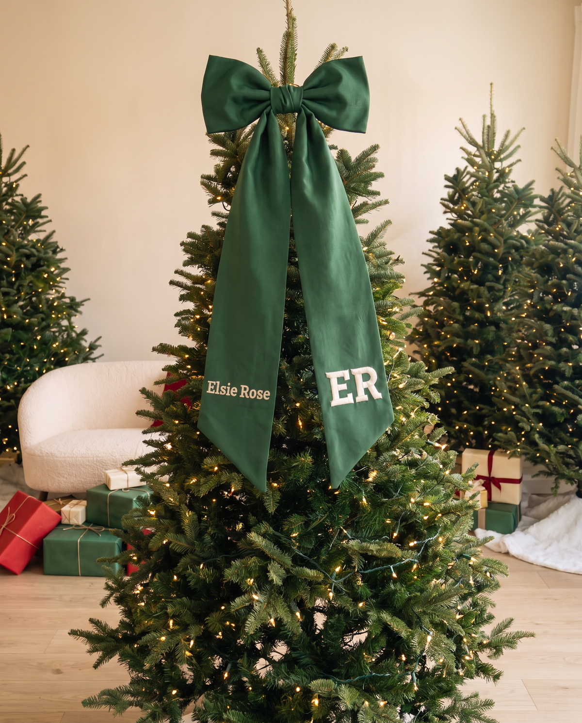 Forest green bow sash used as a Christmas tree topper accent with gifts below