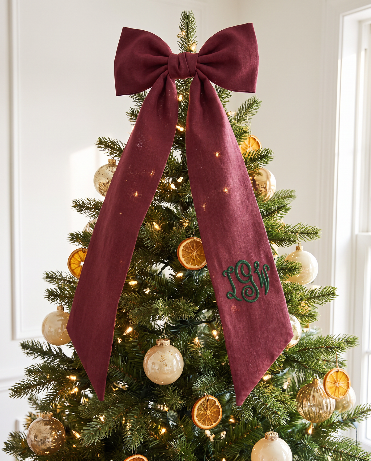 Burgundy bow sash as Christmas tree topper