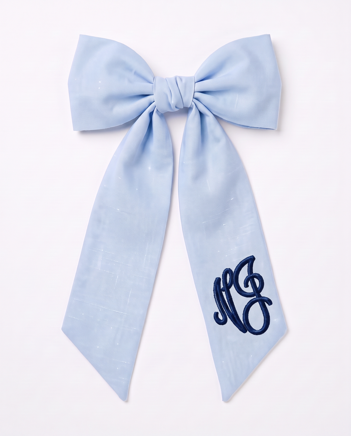 Light blue linen-cotton newborn bow sash with navy monogram embroidery, on white