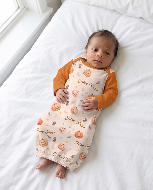 Baby in the personalized sleep gown in Golden Jack pumpkin print, full length view