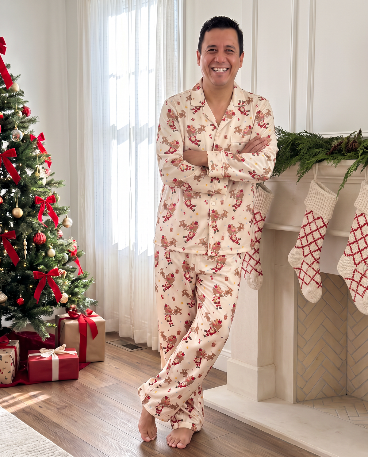 Man in the Santa's Joyride long sleeve pajama set by the Christmas tree and fireplace