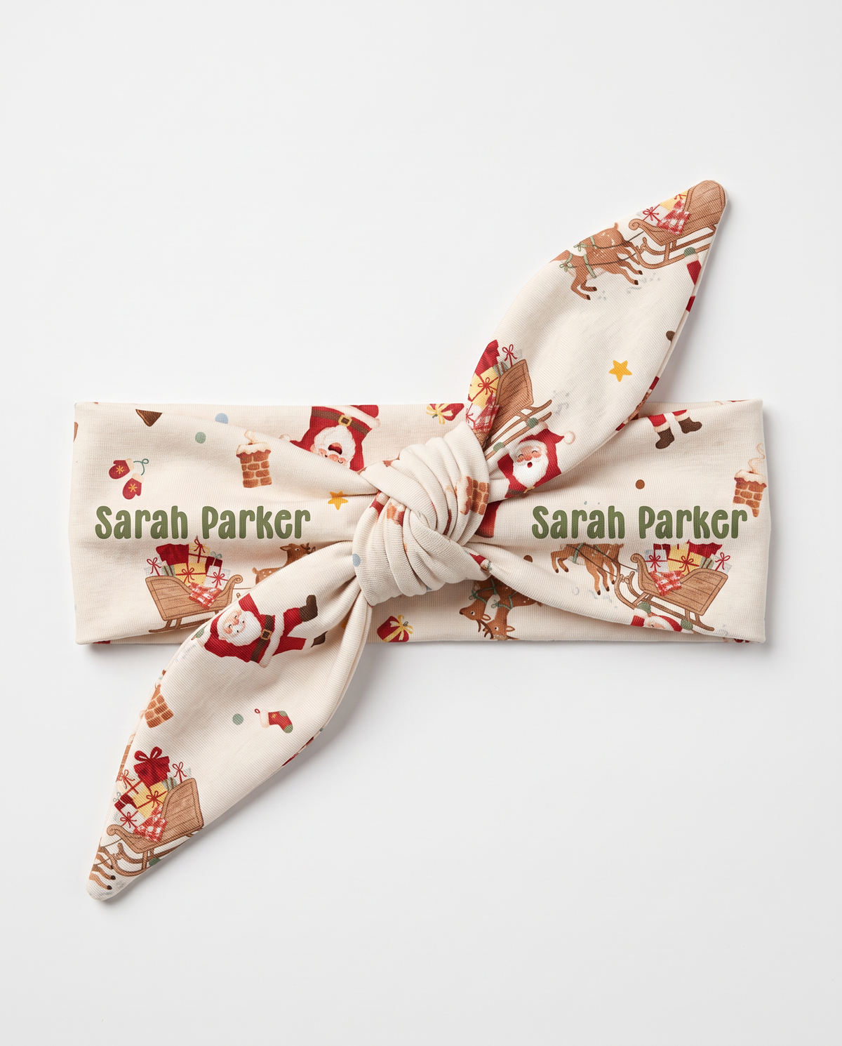 Personalized Santa's Joyride knotted headband with the baby's name, on white