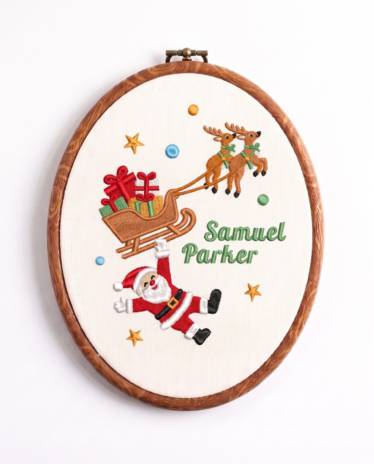 Embroidered hoop sign with Santa hanging from the reindeer sleigh and full name, design 1