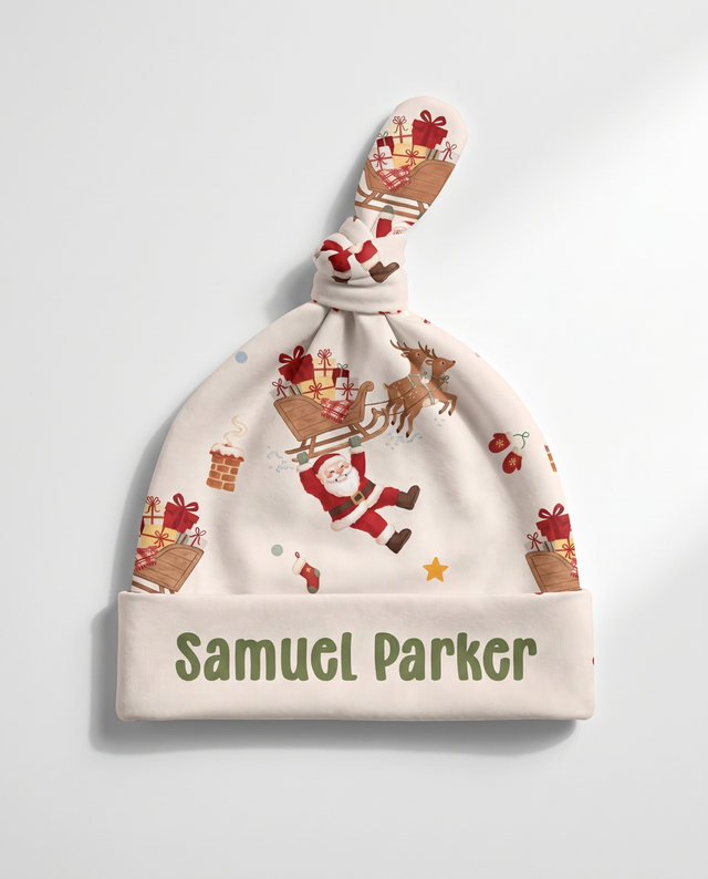 Personalized Santa's Joyride knotted hat with the baby's name on the cuff