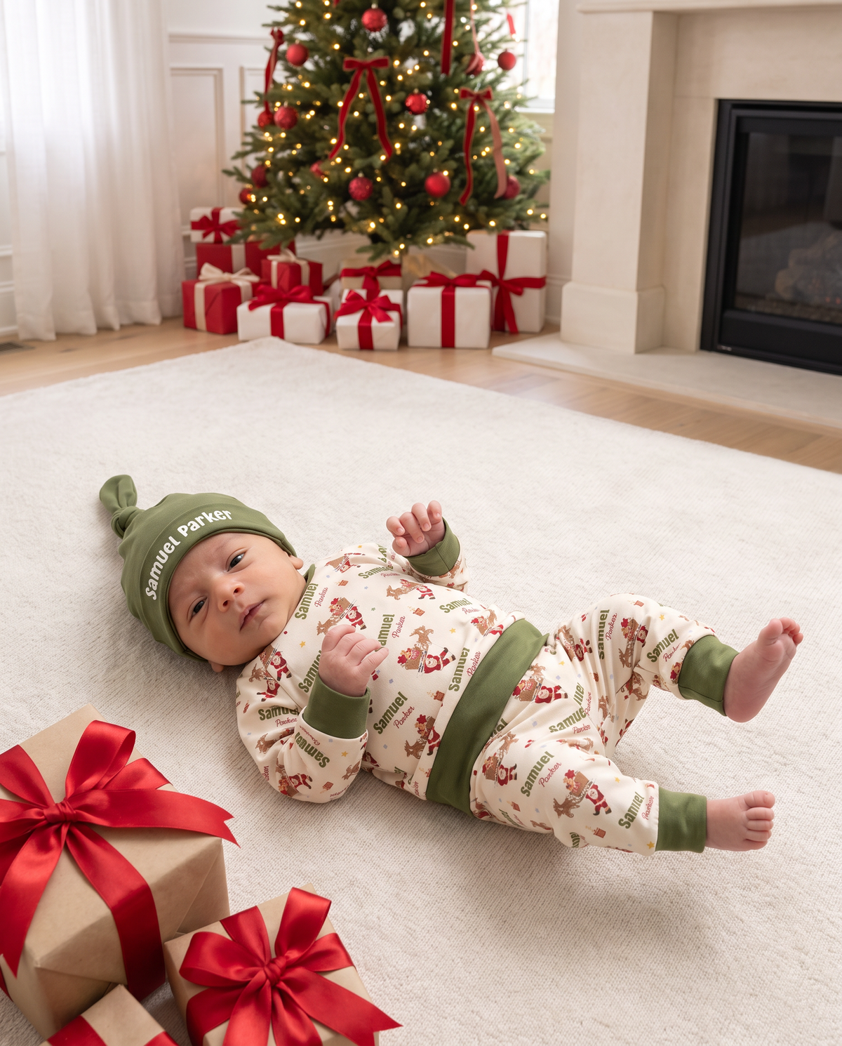Baby in the Santa's Joyride pajama set lying on a rug next to Christmas gifts
