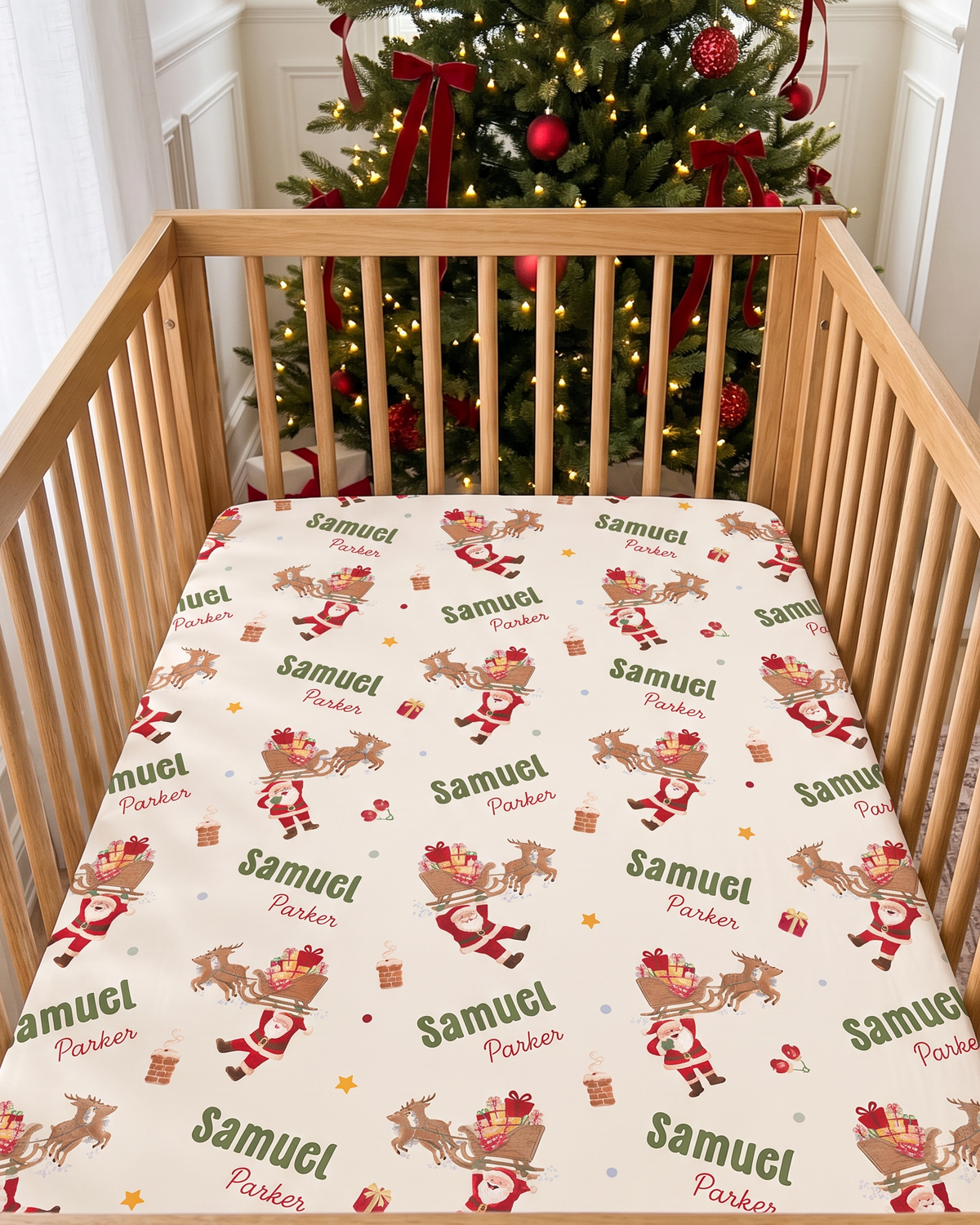 Personalized Santa's Joyride crib sheet fitted on a wooden crib in front of a Christmas tree