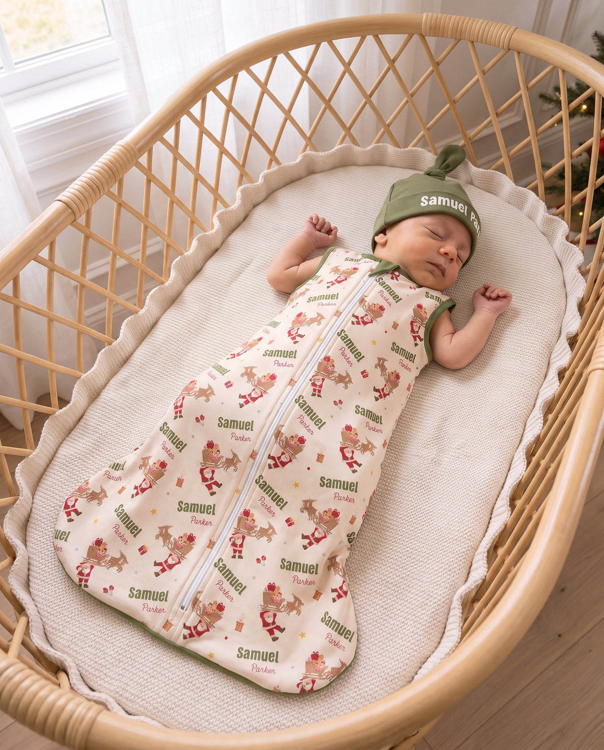 Sleeping baby in Santa's Joyride sleep bag and matching knotted hat, in a rattan bassinet