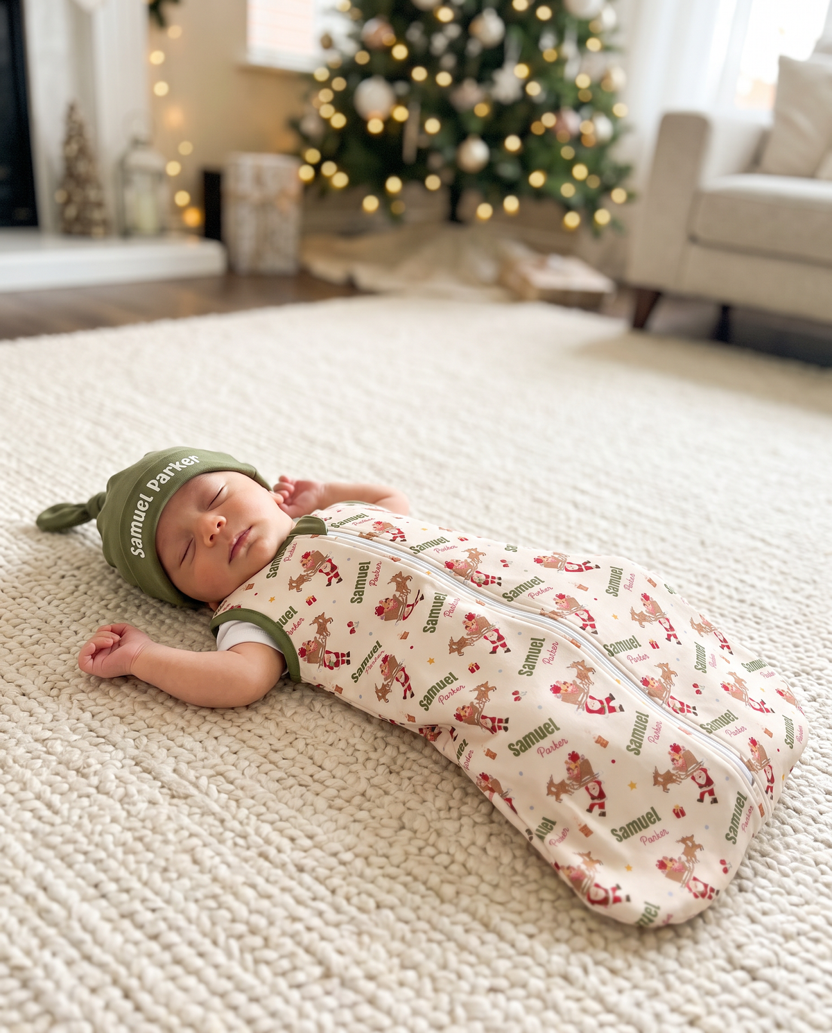 Baby asleep in Santa's Joyride sleep bag on a soft rug near the Christmas tree