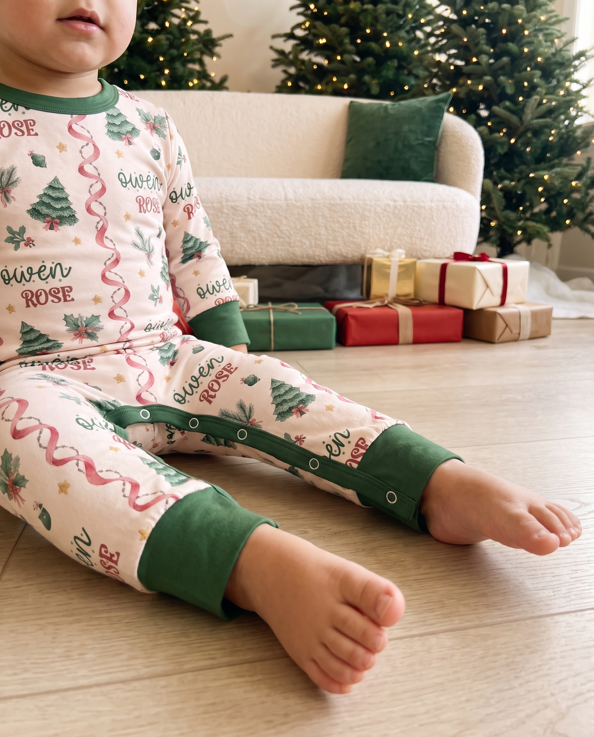Close-up of the Sweetly Trimmed print on the long-sleeved snap romper